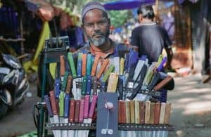 a man on a motorcycle with a basket full of crayons